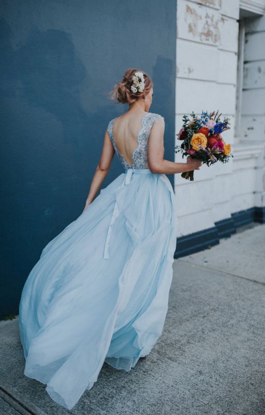 a beautiful ice blue winter wedding dress with a fully embellished bodice, a cut out back and a flowy and light skirt is adorable