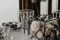 a beautiful modern wedding centerpiece of a cube, white and blush blooms and thin and tall grey candles is a lovely idea for a refined modern wedding