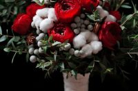 a beautiful winter wedding bouquet of red roses, cotton, berries and greenery and fir branches is a fit for a Christmas wedding