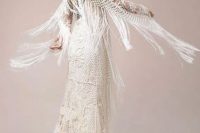 a boho crochet mermaid wedding dress with long fringe on the back and sleeves, a small train feels very wild and free-spirited