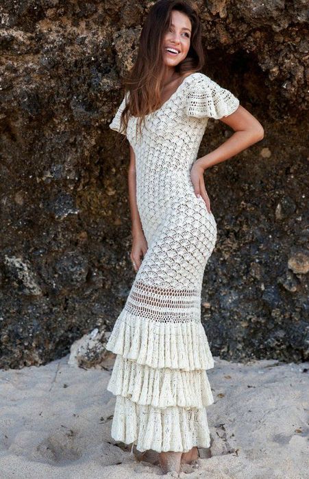 a boho fitting crochet wedding dress with a scoop neckline, short sleeves and a tiered ruffle skirt is a lovely solution for a wild bride