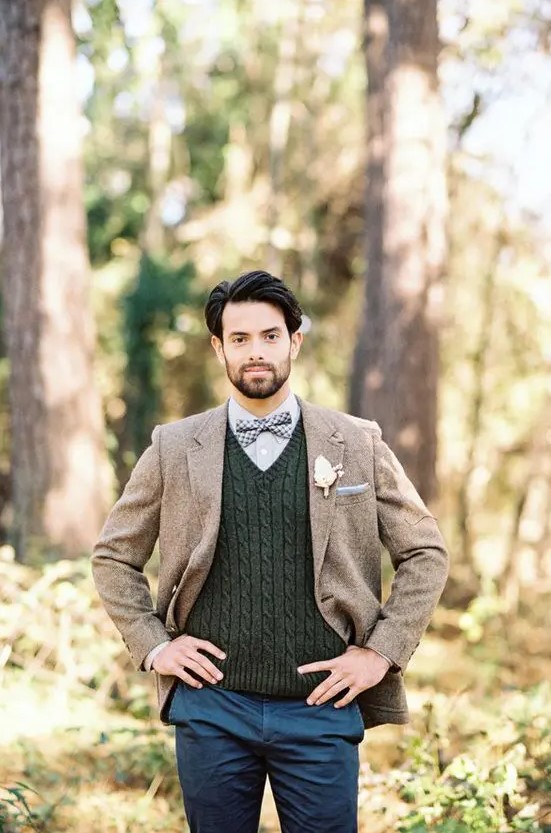 a boho groom's look with a grey shirt, a graphite grey cable knit waistcoat, a beige woolen blazer, navy pants