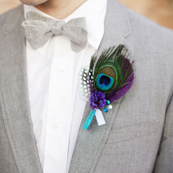 a bright peacock feather boutonniere with a touch of purple and turquoise