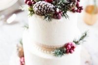 a chic Christmas wedding cake with ribbons, berries, fir twigs, pinecones is always a good idea for a holiday wedding