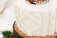 a cool wedding cake with a cable knit tier and a naked one topped with fresh greenery is a lovely winter decor idea