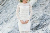 a crochet A-line wedding dress with an illusion neckline and long sleeves, a greenery and neutral floral crown for a cool boho bridal look