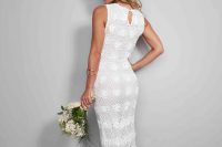a dreamy crochet mermaid wedding dress with a high neckline and no sleeves, a slight train, a pink floral crown adds a girlish touch
