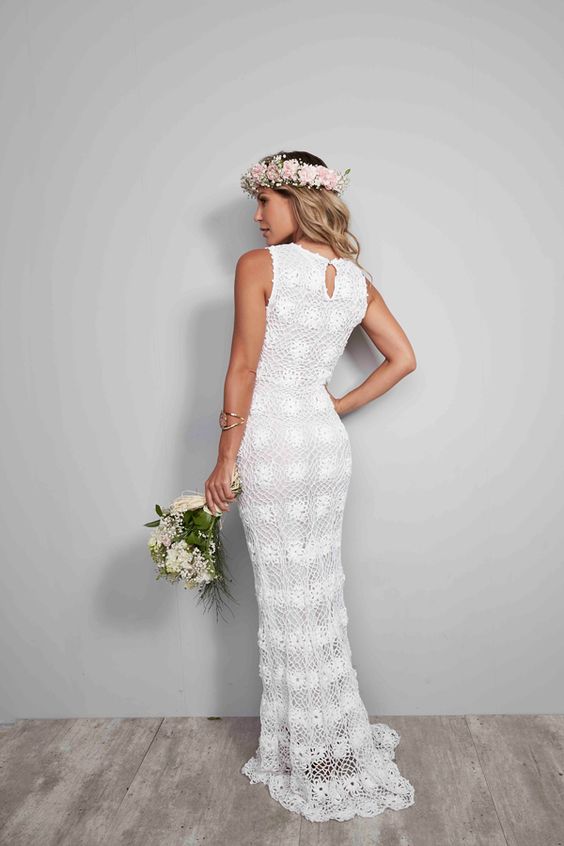a dreamy crochet mermaid wedding dress with a high neckline and no sleeves, a slight train, a pink floral crown adds a girlish touch