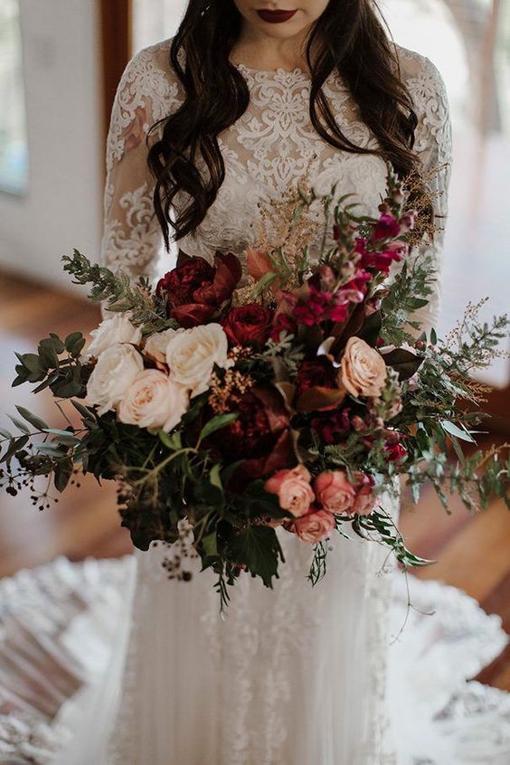a gorgeous Christmas wedding bouquet of white, pink and burgundy blooms, touches of fuchsia and lots of greenery
