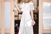 a lovely modern off the shoulder crochet midi wedding dress with a ruffle neckline, lace up polka dot shoes and a white clutch