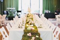 a moss table garland with pastel blooms will do for a tea party wedding or an Alice In Wodnerland one