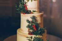 a naked wedding cake with berries, fit branches and pinecones plus some white blooms is classics with a rustic touch