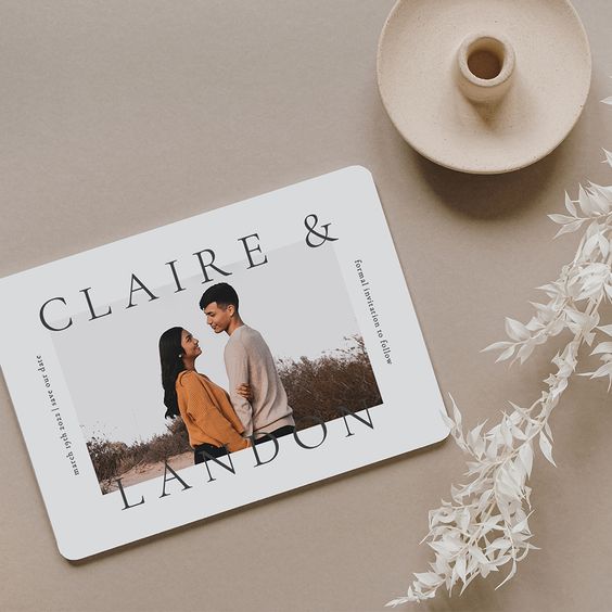 a neutral save the date with a colored couple's photo and black printing is a cool and bold idea for a wedding