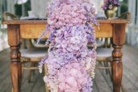 a pink and purple hydrangea floral table garland is a gorgeous floral statement at your reception