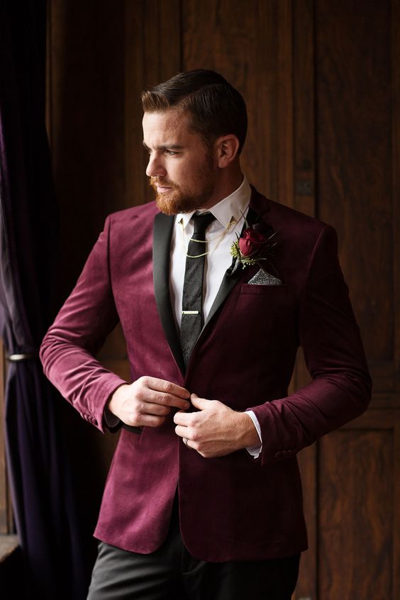 a plum colored velvet tux, a white button down, a black suit, black pants and some chains for an accent