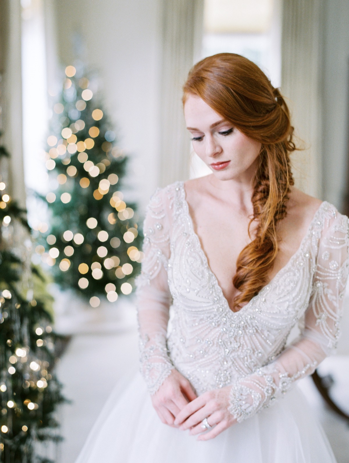 A romantic embellished wedding ballgown with a deep V neckline, long sleeves and a plain full skirt is a beautiful idea