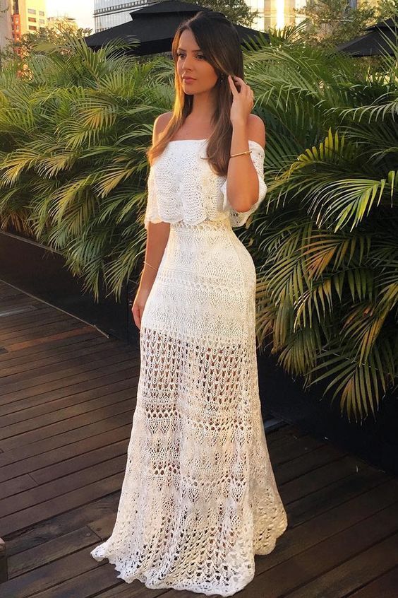 a romantic off the shoulder crochet two piece wedding dress with a crop top and short sleeves plus a maxi skirt for a boho wedding