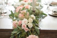 a seeded eucalyptus wedding table garland with white and blush blooms and silver candles is a chic idea