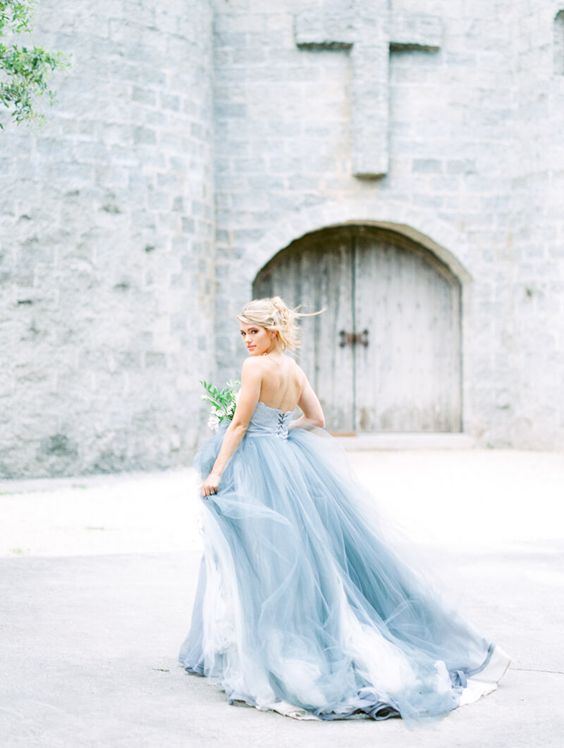 a strapless icy blue wedding ballgown with a layered skirt with a train is a fit for an ice queen