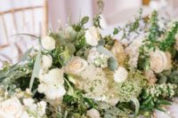 a super lush greenery and neutral bloom wedding table garland will make a beautiful statement in decor