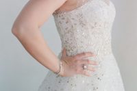a super shiny A-line wedding dress with an illusion neckline and lots of silver sequins for a chic and glam look