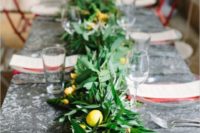 a textural greenery garland with yellow blooms and lemons for a Tuscany wedding
