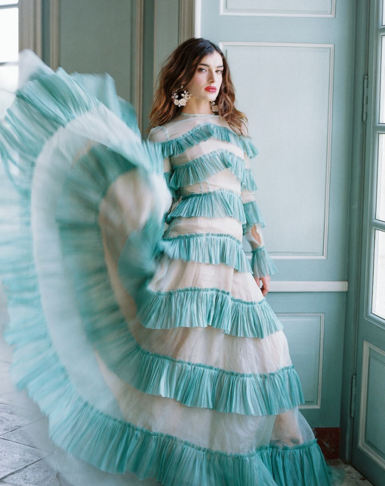 A unique mint ruffle wedding dress with long sleeves and a high neckline is a bold option for a non traditional bride