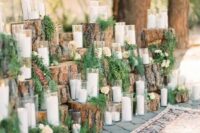 a wedding candle display made of tree stumps, fern and greenery and lots of candles is a lovely idea for a woodland or rustic wedding