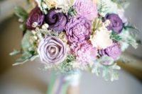 a whimsy purple, lavender and mint-colored wedding bouquet with lots of blooms and greenery