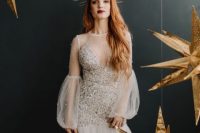 a whimsy wedding dress with sivler sparkles, puff sleeves, a layered skirt plus a sunburst crown