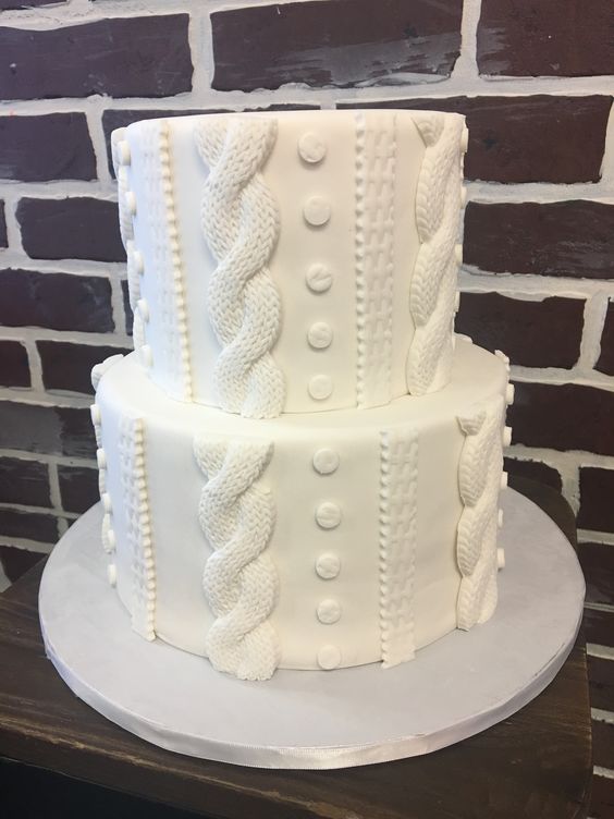 a white cable knit wedding cake is a very creative and fun idea for a winter wedding, skip all the green and red cakes