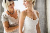 a white sequin spaghetti strap sheath wedding dress features a traditional bridal color and a sexy design