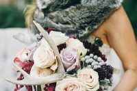 a woodland wedding bouquet with blush and lavender blooms, berries and dark blooms plus antlers