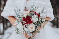 an ethereal Christmas wedding bouquet of blush, white and red blooms and pale and snowy foliage is amazing