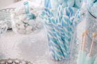 an ice blue and silver winter wedding dessert table is a gorgeous and bold idea for a winter celebration
