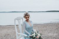 an ice blue winter wedding dress with a lace bodice and a layered skirt with a train is a gorgeous idea to rock