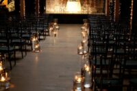 an industrial wedding ceremony space with lights, rows of chairs and floating candles is a stylish space