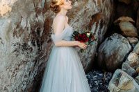 an off the shoulder ice blue wedding dress with a draped bodice is a beautiful idea to go for
