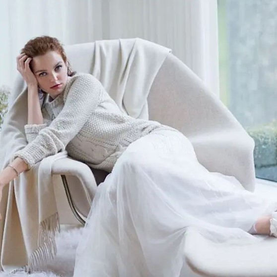 an off-white bridal sweater over a white wedding dress will give you a very soft and girlish look