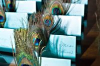 blue cards with peacock feathers make the place cards bold and chic