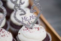 chocolate cupcakes topped with pretty silver glitter anlters are amazing for a woodland wedding