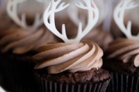 chocolate cupcakes topped with sugar antlers are amazing for a fall or winter woodland wedding
