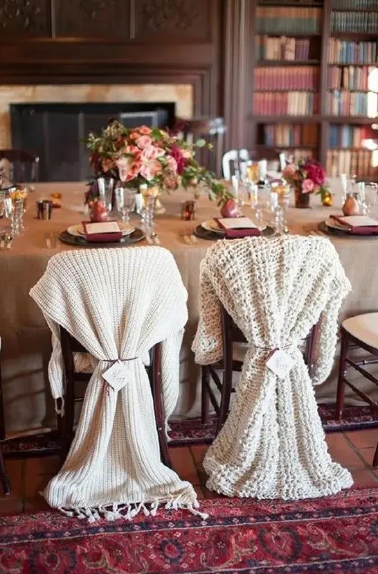 Differently knit chair covers for the bride and groom instead of usual signs look very winter like