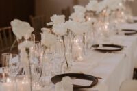 modern cluster wedding centerpieces of white roses and small candles are a chic and lovely idea for a modenr sophisticated wedding