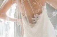 a beautiful cathedral wedding veil with glittering snowflakes is a chic and lovely idea for a winter bride
