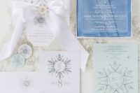 a beautiful snowflake wedding invitation suite with paper and clear acrylic pieces, printed and 3D snowflakes with rhinestones