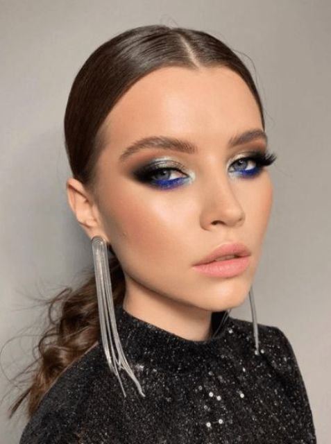 a bold makeup for a NYE wedding, with a matte pink lip, silver metallic and electric blue eyeshadow, lash extensions