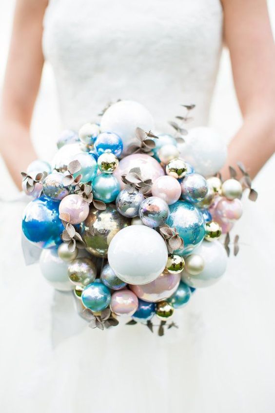 a catchy winter wedding bouquet of pink, blue, silver and metallic ornaments plus gilded branches is amazing for a holiday wedding