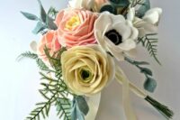 a cool felt flower wedding bouquet with felt anemones, roses and ranunculus, greenery and pastel ribbon is cool