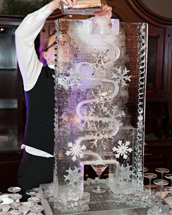 a frozen sculpture with snowflakes and thinestones is a fantastic idea to serve drinks at your winter wedding